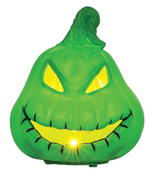 Green Halloween-themed light with a face on a white background