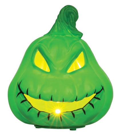 Green Halloween-themed light with a face on a white background