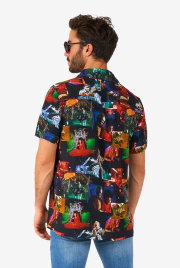 Man wearing a colorful patterned shirt with a white background
