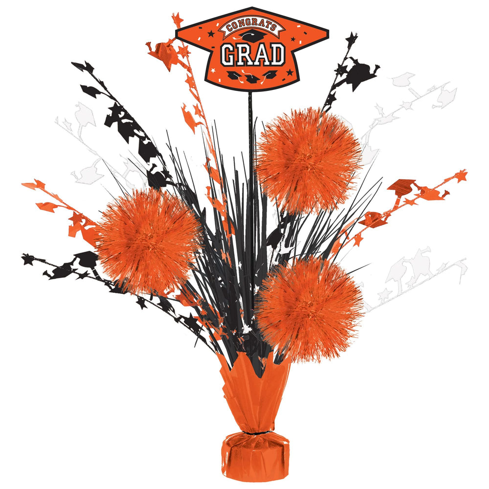 Graduation-themed centerpiece with orange and black decorations on a white background