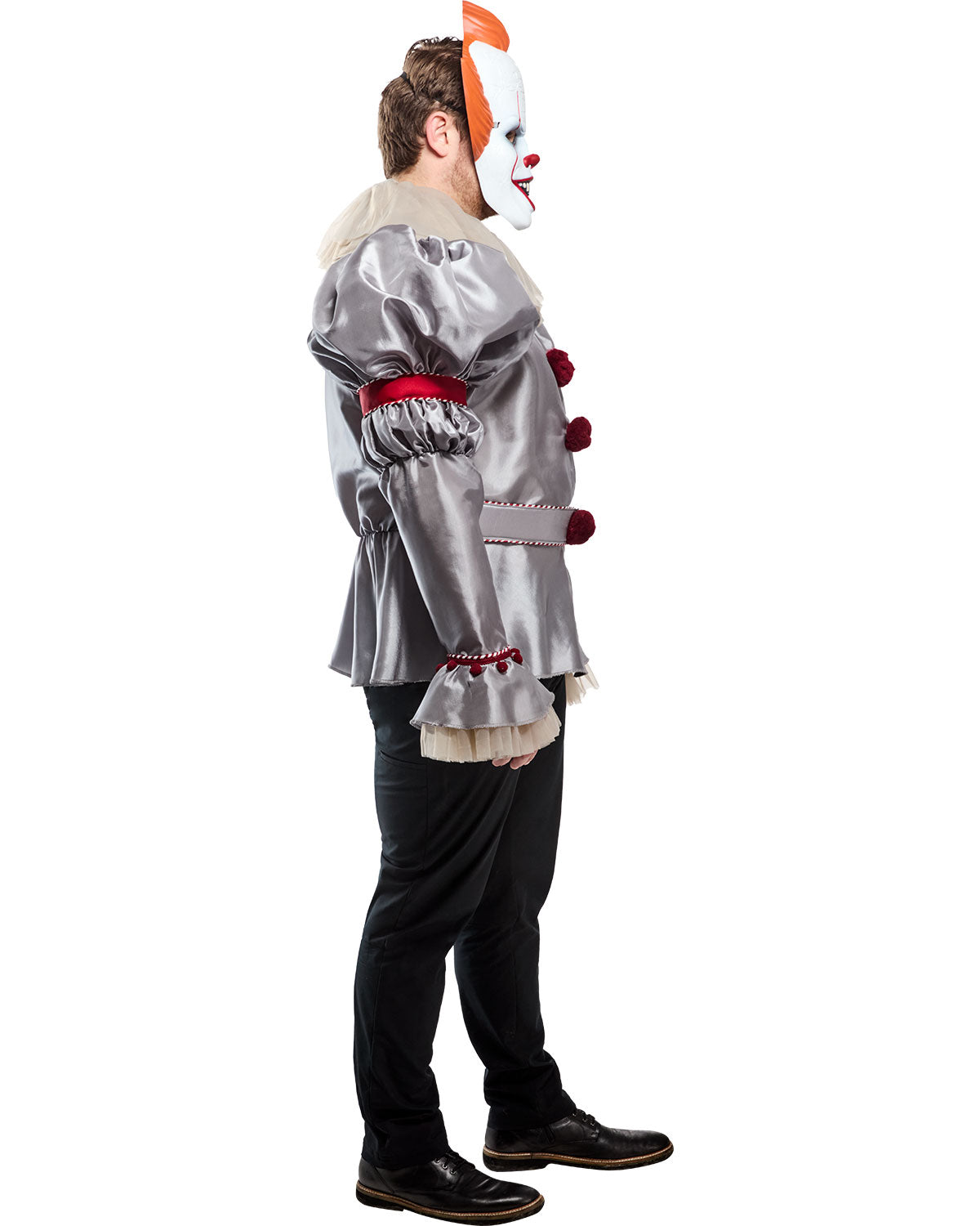 Person wearing a silver clown costume with red accents on a white background