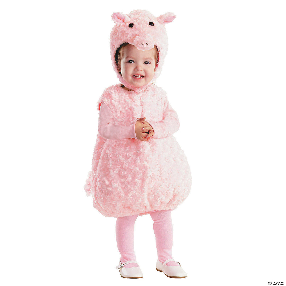 Child wearing a pink pig costume on a white background