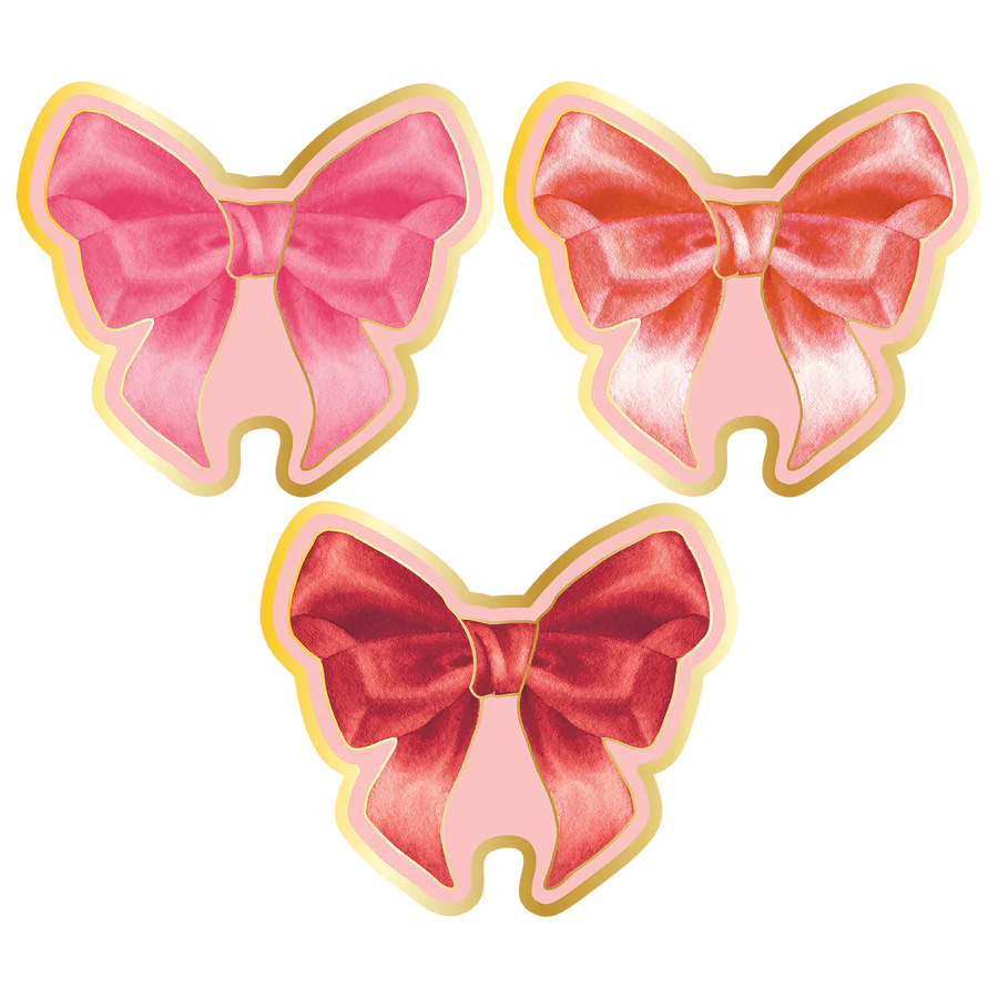 Three pink bow-shaped cookies on a white background