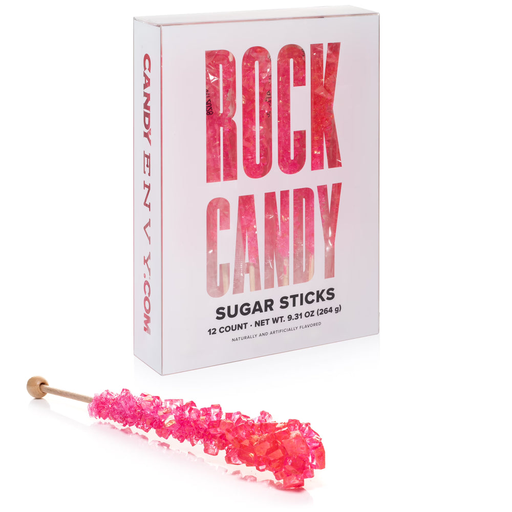 Box of Rock Candy Envy sugar sticks with a pink candy stick in front on a white background