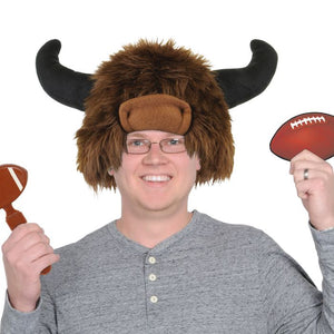 Person wearing a bison hat with horns, holding footballs on a white background