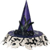 Purple witch hat with green feathers on a tablecloth with black cat designs.