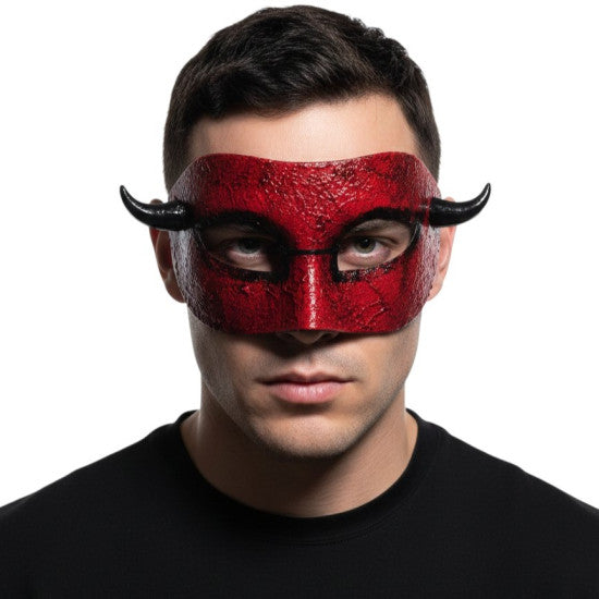Person wearing a red mask with black horns on a white background