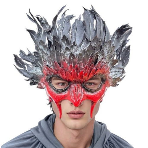 A man wearing a striking red and black feathered mask with dramatic spiky feathers, shown against a plain white background.