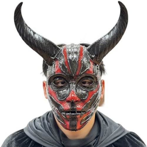 A person wearing a horned devil mask with black, red, and gray painted details, paired with a dark gray hoodie, against a plain white background.