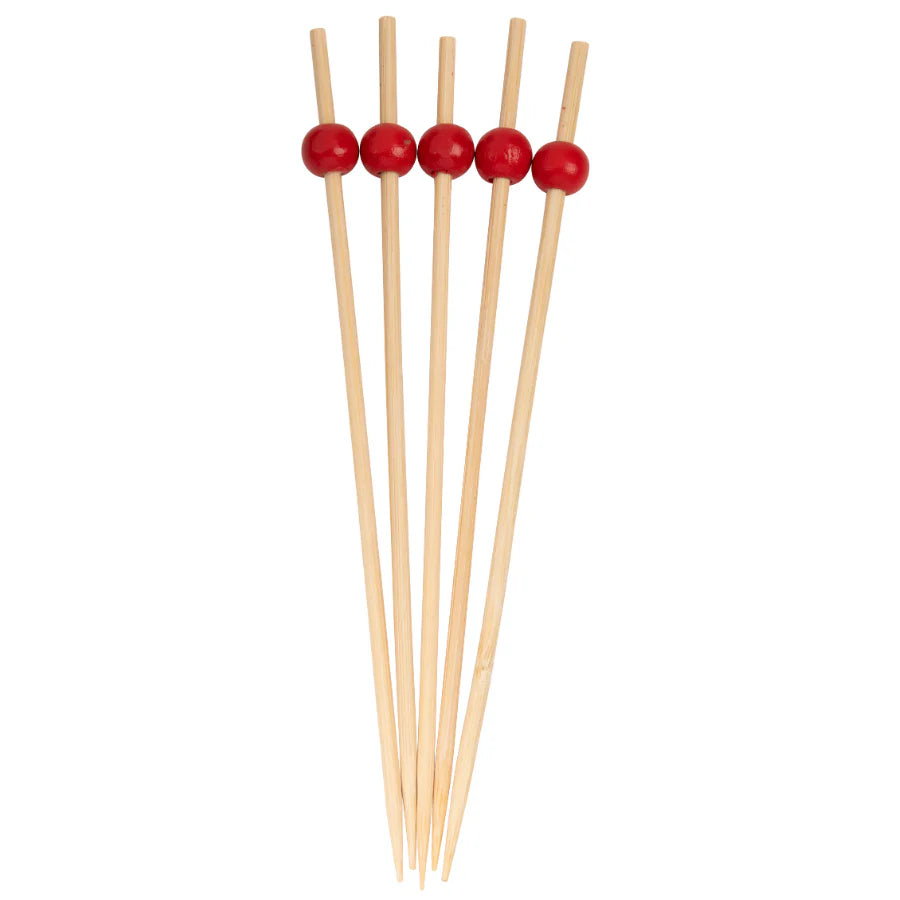 Set of wooden skewers with red beads on a white background