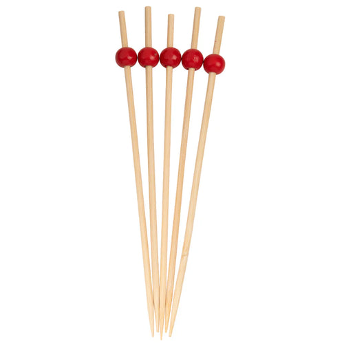 Set of wooden skewers with red beads on a white background