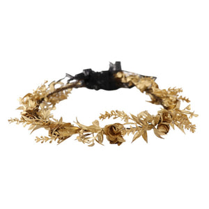 Gold floral headband with black bow on a white background