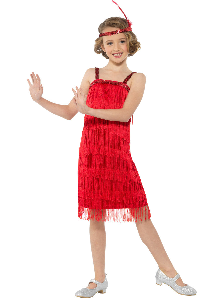Young girl wearing a red fringe dress with a matching headband on a white background