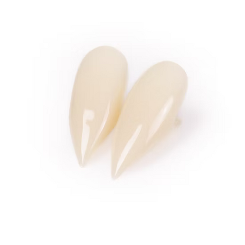 A pair of glossy, nude beige stiletto press-on nails on a clean white background.