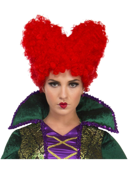 Person wearing a red heart-shaped wig with a green and purple costume on a white background