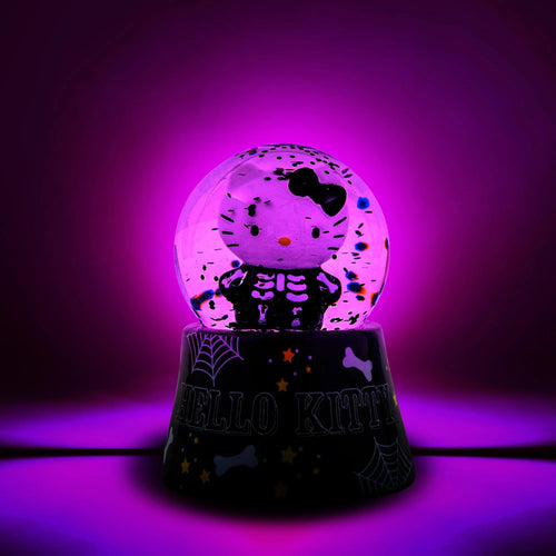 Glowing purple snow globe with Hello Kitty design on a black base against a purple background