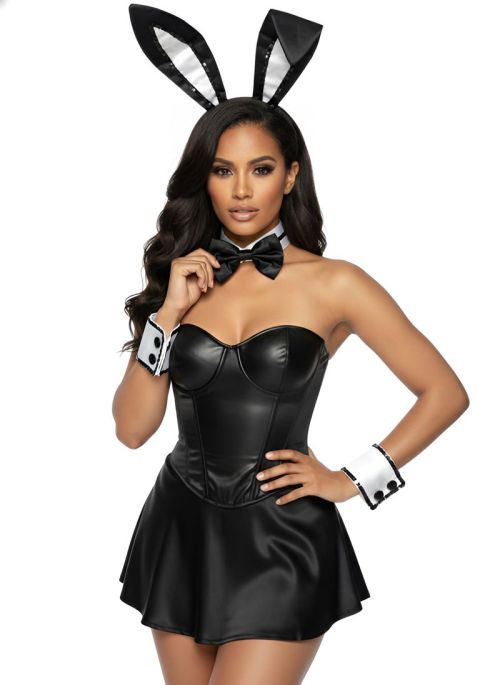 Woman wearing a black bunny costume with ears, bow tie, and cuffs on a white background