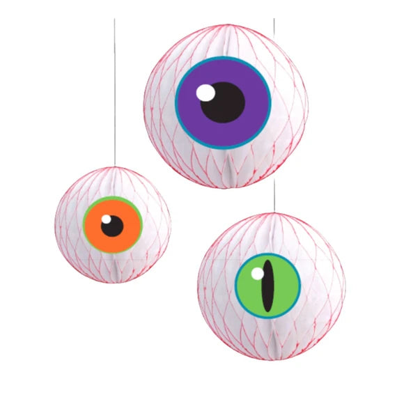 Three hanging paper lanterns shaped like eyeballs in different sizes, featuring white textured bodies with red stitched details and colorful printed eyes in purple, orange, and green.
