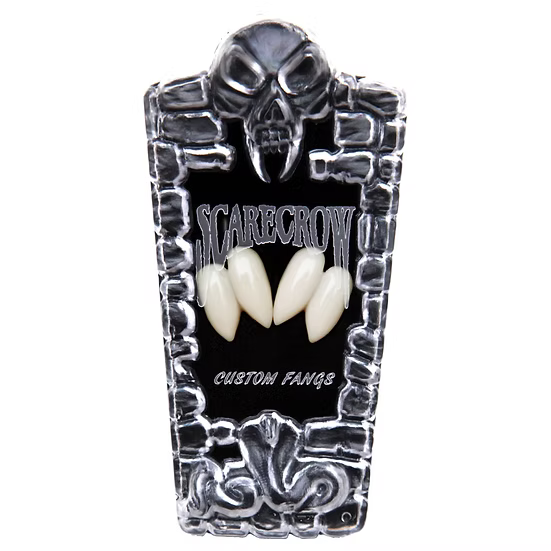A coffin-shaped display case for custom teeth or fangs, featuring a skull at the top, a black center panel with the words 'SCARECROW' and 'CUSTOM FANGS,' and three cream-colored fangs displayed in the middle, all on a white background.