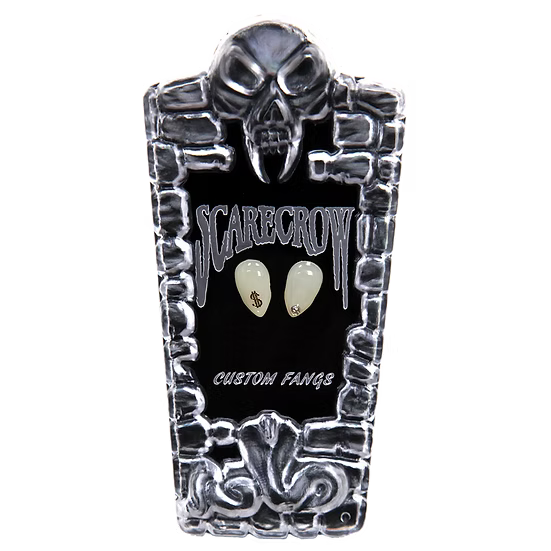 A coffin-shaped display case for custom teeth-shaped accessories, featuring a skull design on a black background with the words 'SCARECROW' and 'CUSTOM FANGS' in white. Two cream-colored tooth-shaped pieces are displayed in the center.