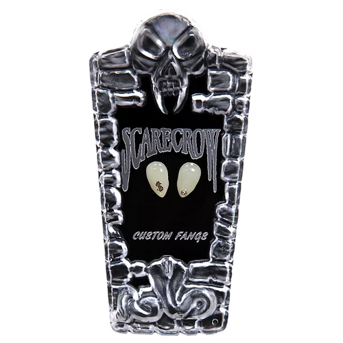 A coffin-shaped display case for custom teeth-shaped accessories, featuring a skull design on a black background with the words 'SCARECROW' and 'CUSTOM FANGS' in white. Two cream-colored tooth-shaped pieces are displayed in the center.