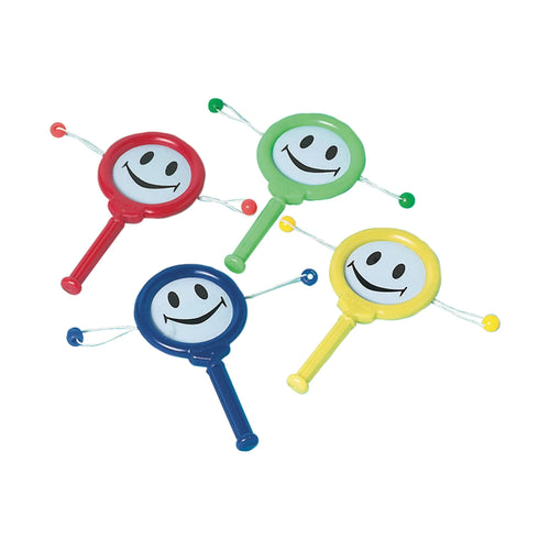 Four colorful rattles with smiley face designs on a white background