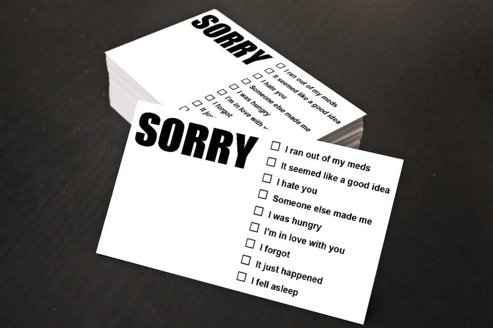 Two 'Sorry' cards with checkboxes on a dark surface