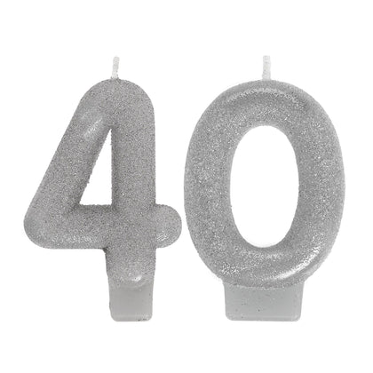 Silver glittery number candles spelling '40' on a white background