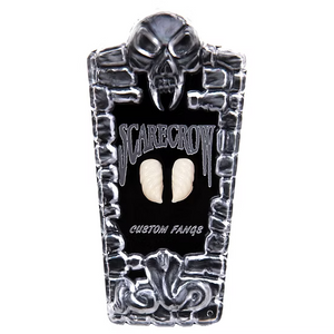 A black and silver coffin-shaped display stand featuring a skull at the top, the words 'SCARECROW' and 'CUSTOM FANGS', and two cream-colored custom teeth mounted in the center, shown on a plain white background.