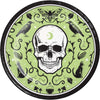 Circular design with a skull, birds, and other elements on a green background