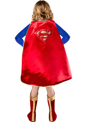 Child wearing a red superhero cape with a visible logo on a white background