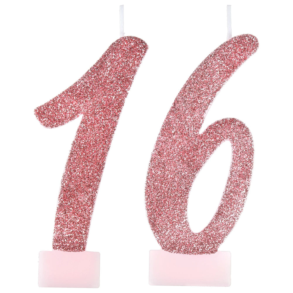 Pink glittery number '16' candle on a white background