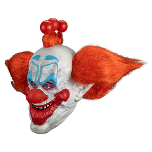 Clown mask with red hair and makeup on a white background