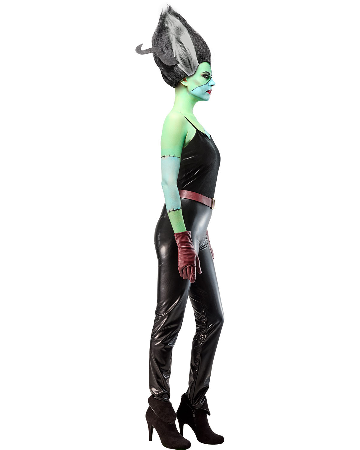 Person wearing a futuristic costume with black leather outfit and green accents on a white background