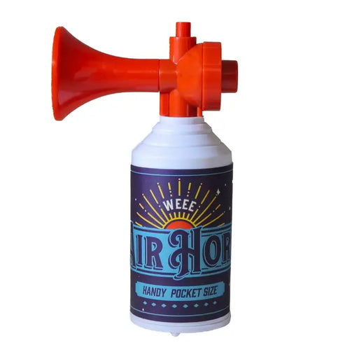A pocket-sized air horn featuring a bright red horn-shaped mouthpiece attached to a white cylindrical canister with a dark purple label that reads 'WEEZ AIR HORN HANDY POCKET SIZE'.