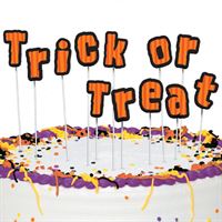 Halloween-themed cake with 'Trick or Treat' text and decorations.