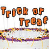 Halloween-themed cake with 'Trick or Treat' text and decorations.