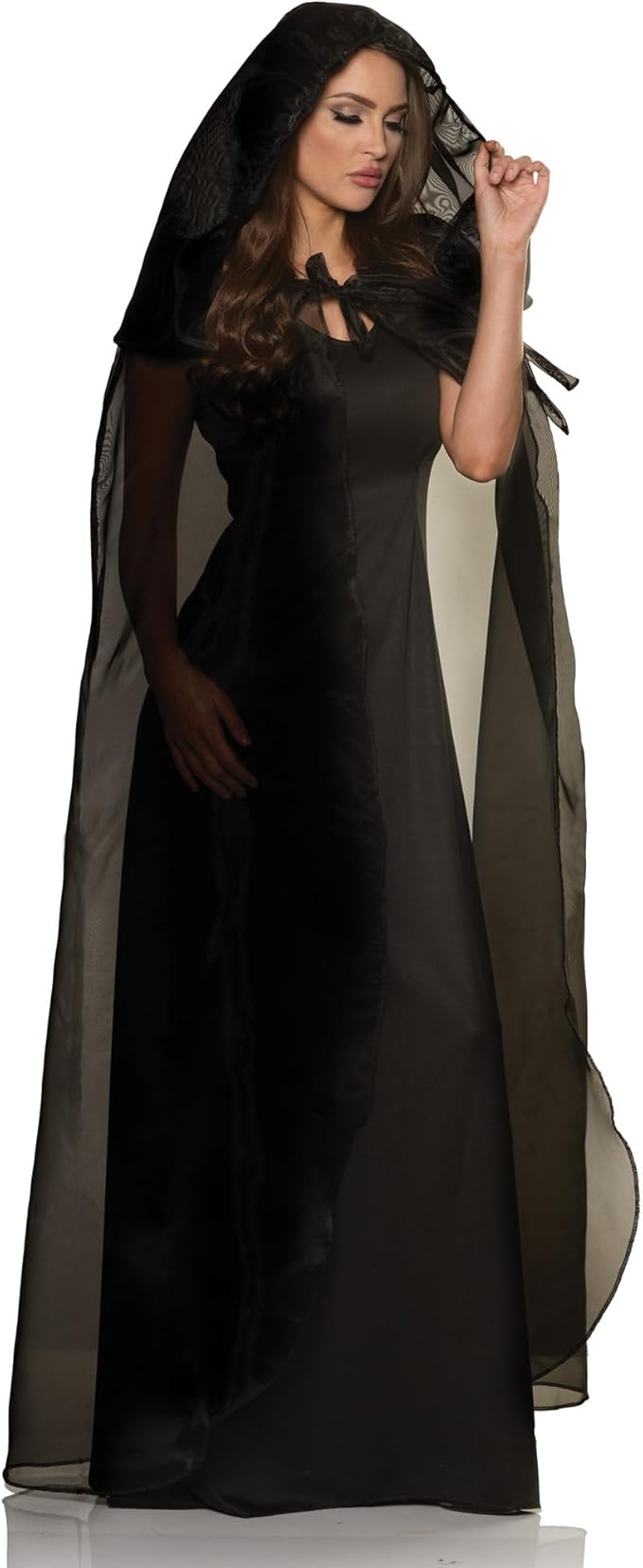 Woman wearing a black dress with a hood on a white background
