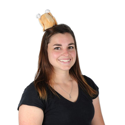 Woman wearing a novelty hat with a cartoonish design on a white background