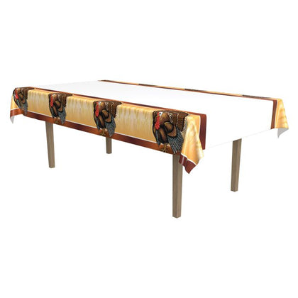 Table with a decorative tablecloth featuring a pattern of a woman and child in a basket on a white background.