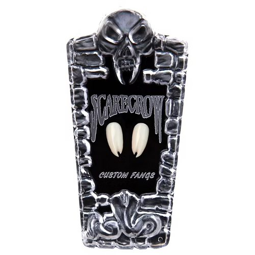 A pair of custom vampire fangs displayed on a black tombstone-shaped stand with a skull and the words 'SCARECROW' and 'CUSTOM FANGS' on a white background.
