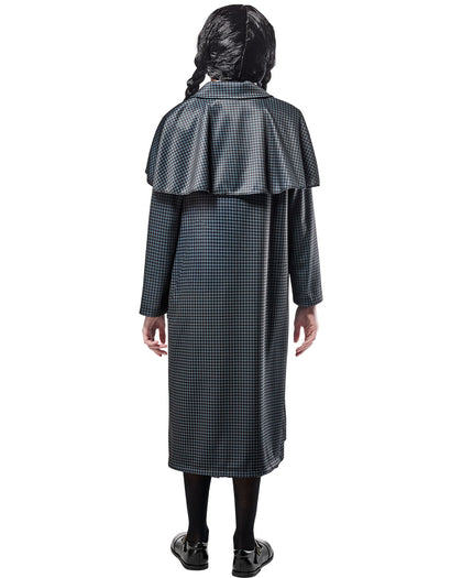 Person wearing a long, dark checkered coat with a cape on a white background