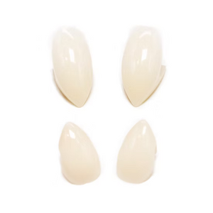 Four glossy, almond-shaped false nails in a warm cream shade, arranged in a 2x2 grid on a solid white background.