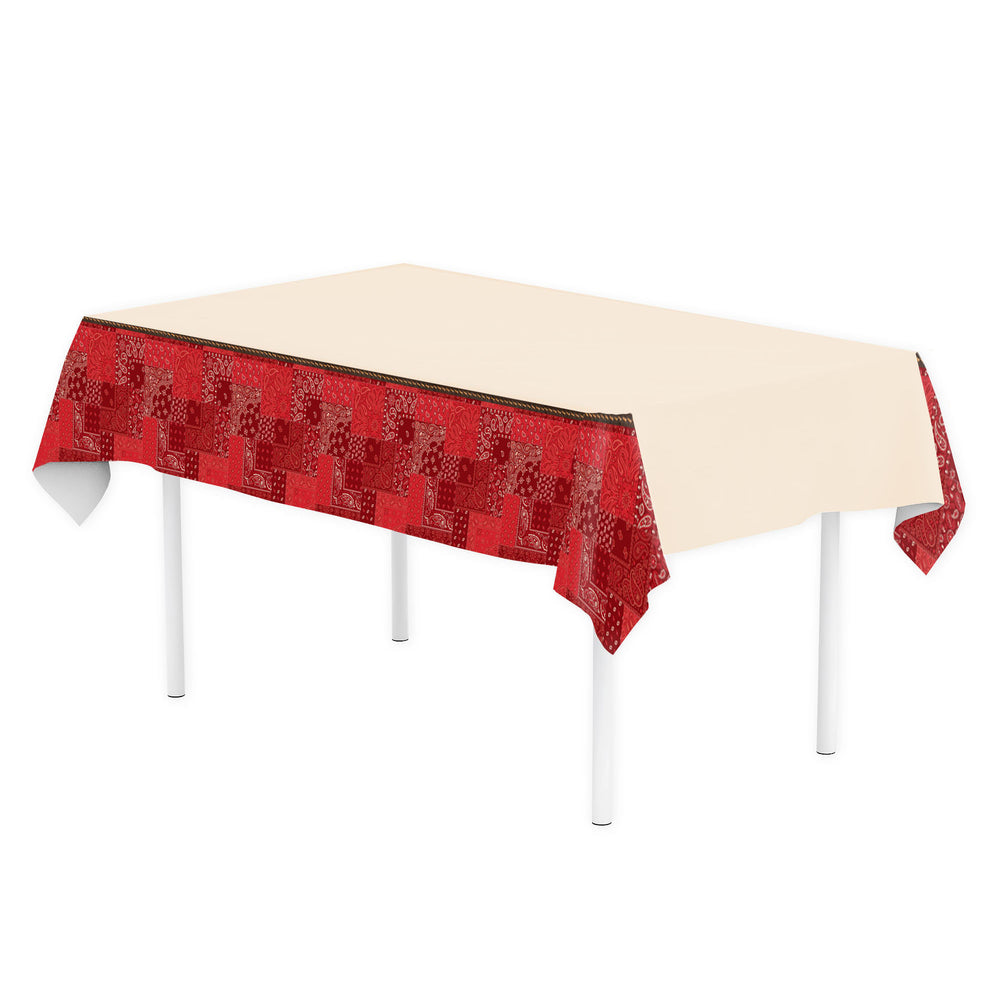 Red patterned tablecloth on a white table with a white background
