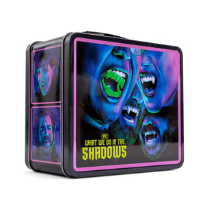 Tin box with 'What We Do in the Shadows' design featuring vampire faces.