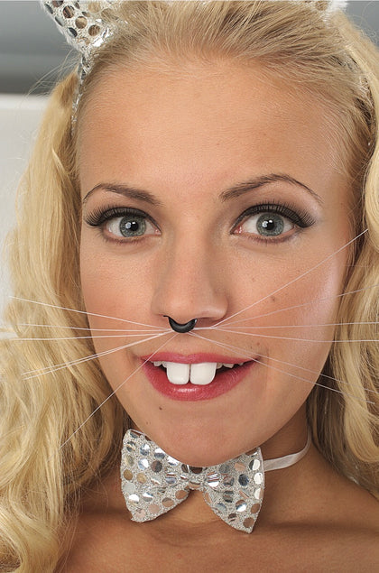 Woman wearing cat ears and a bow tie with a neutral background