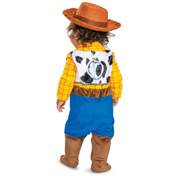 Child wearing a Woody costume from Toy Story on a white background