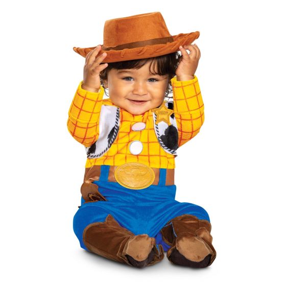 Child wearing a Woody costume from Toy Story with a cowboy hat on a white background
