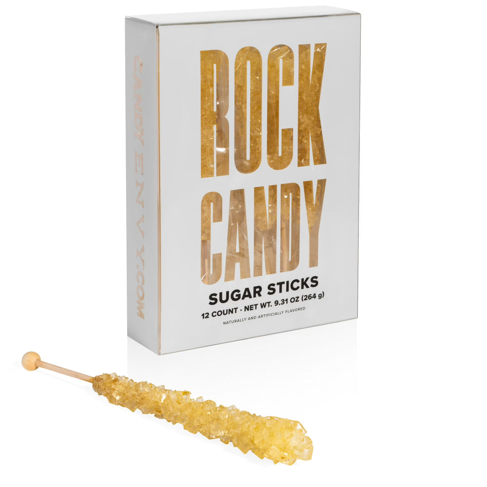 Rock candy sugar stick in front of a white box labeled 'Rock Candy Sugar Sticks'.