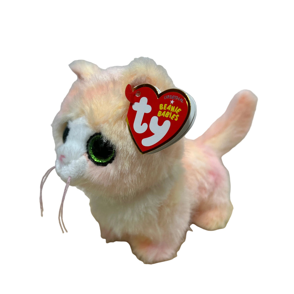 Plush toy with a red heart-shaped tag on a white sheet of paper.